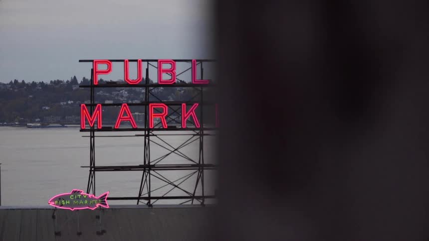 A lit sign stands on a building