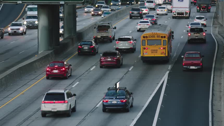 Vehicles driving down a freeway in a city