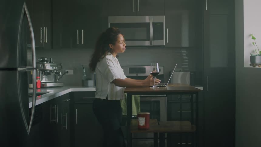 A woman talking on a laptop