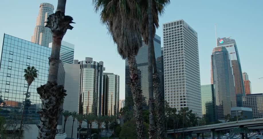 High rise office buildings in a city with cars driving on the streets