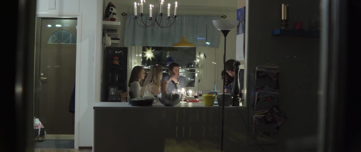 Young adults engaging in lively conversation while sharing a wholesome meal at home.