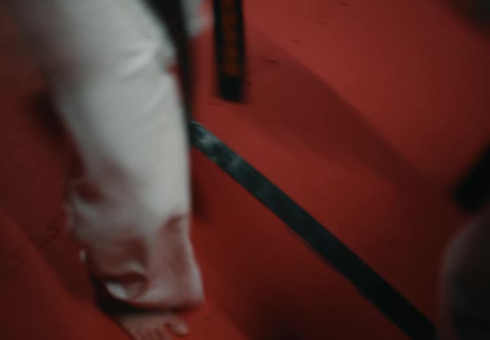 Two female fighters spar each other in a martial arts gym