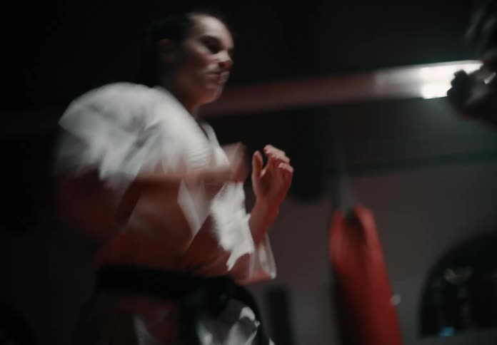 Two people are training together in a gym