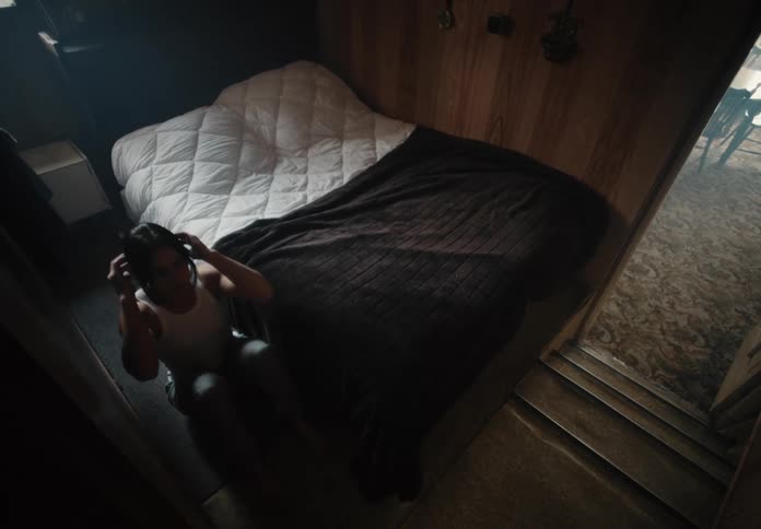 A female athlete does sit ups on the floor of her bedroom