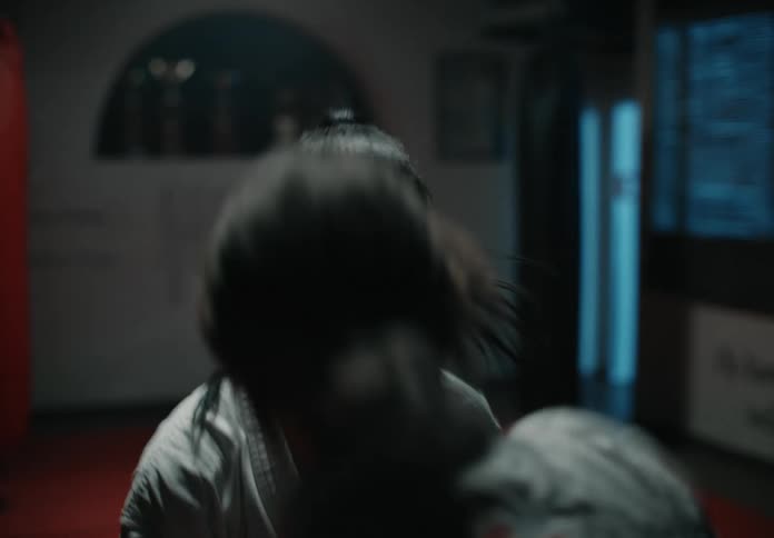 Two young female athletes throw punches as they box