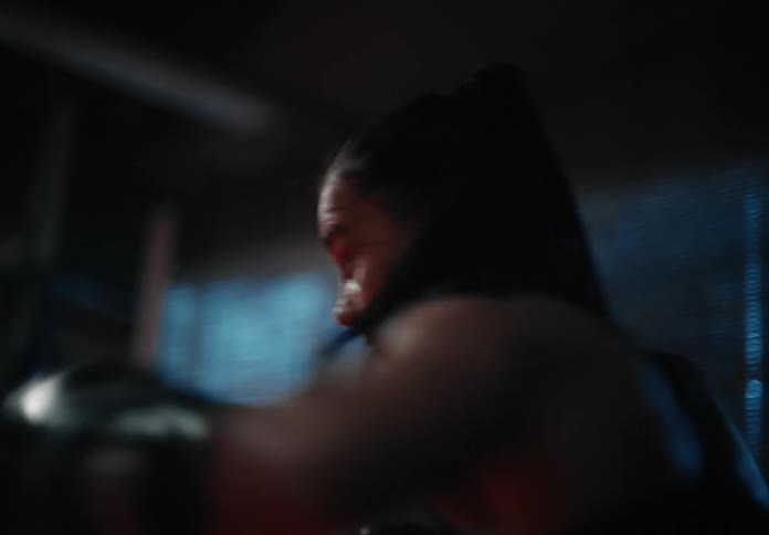 A female athlete throws powerful punches as she boxes