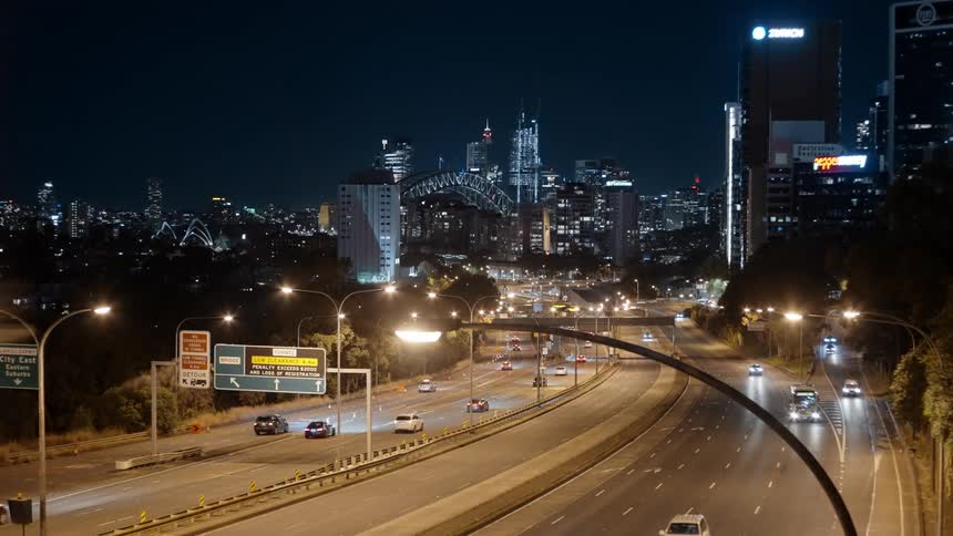 Cars and buses heading to and from a city glowing at night