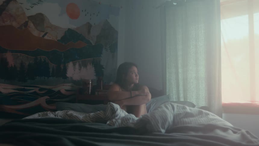 A woman is sitting in bed