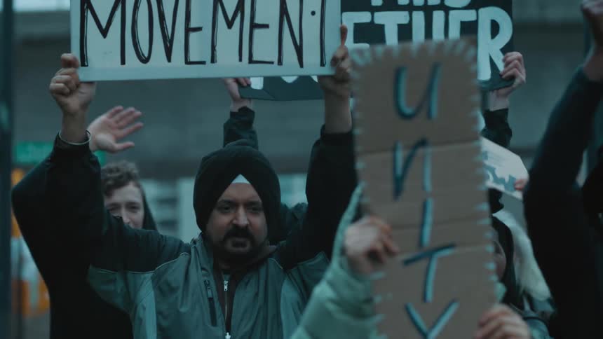 A group of people are protesting outside in the day time
