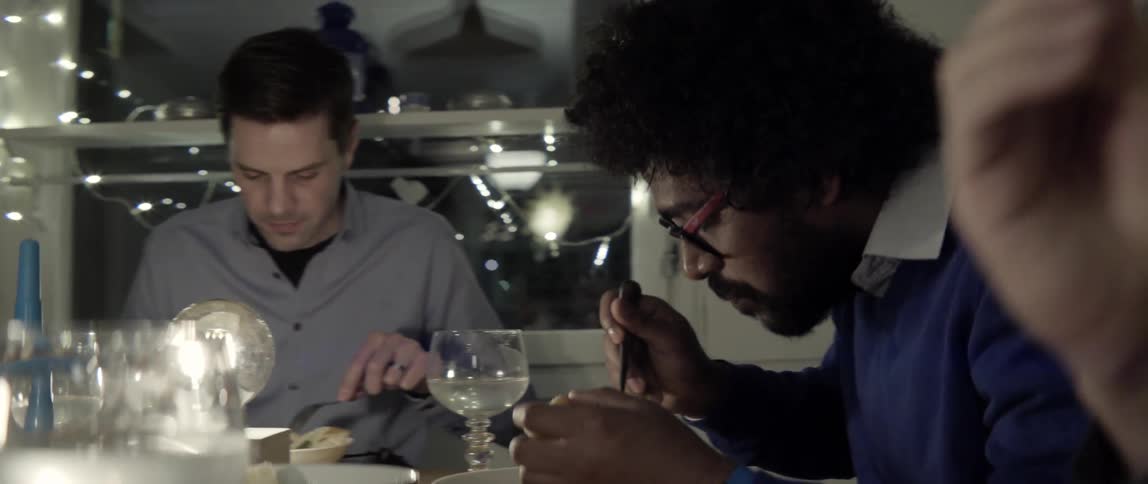 Friends enjoying a cozy dinner party together with laughter and shared conversation
