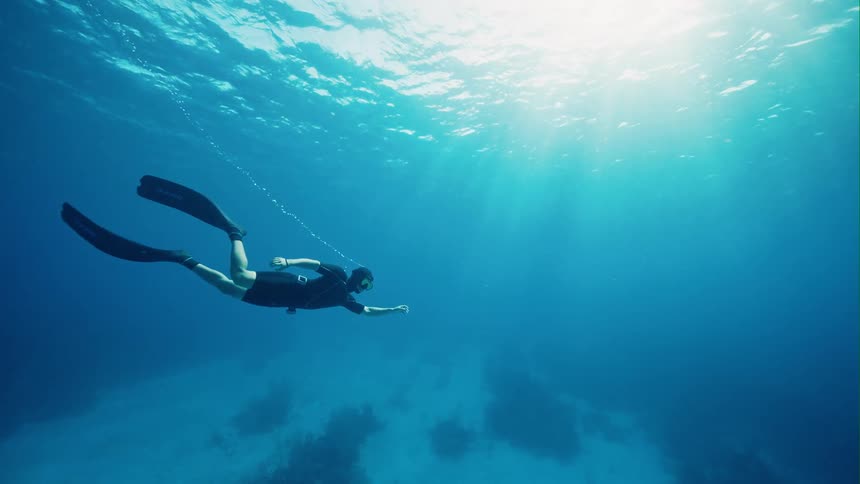 A person swimming underwater