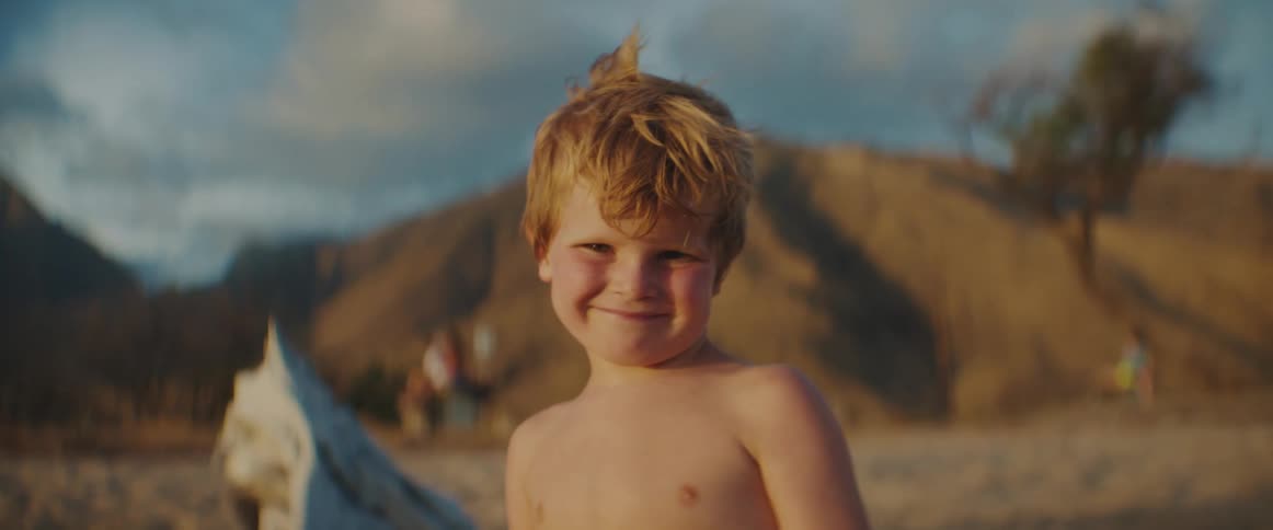 A child smiles on the beach