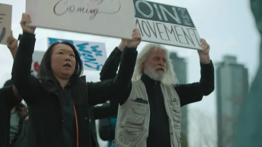 Protesters march with signs outside