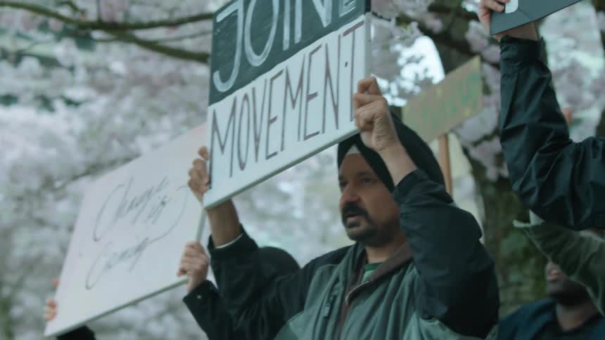 People are carrying signs in a rally