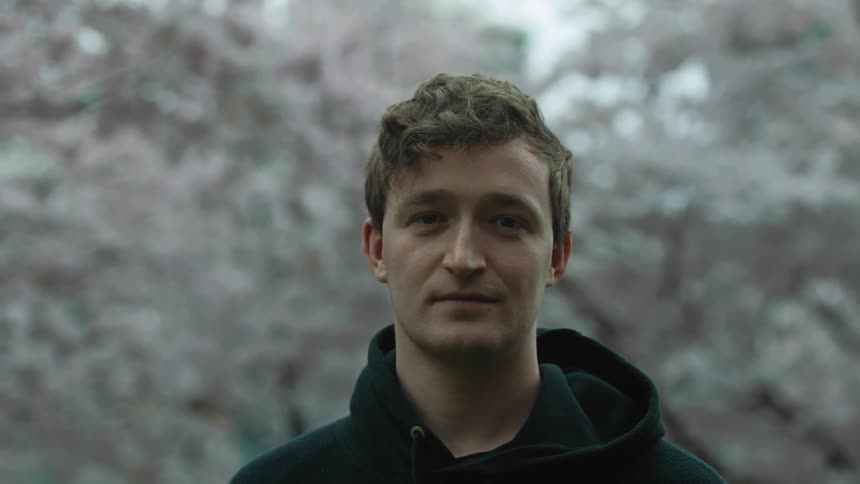 A man smiles outside