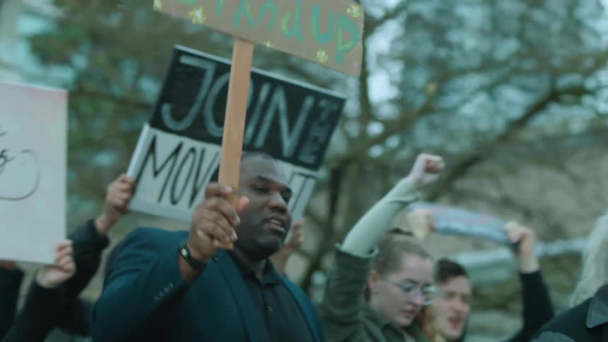 Protesters march with signs together