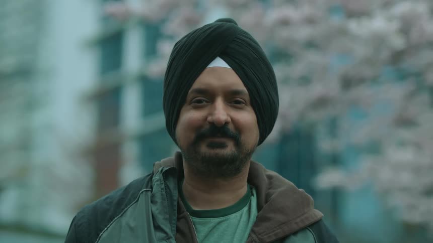 A man smiles outside