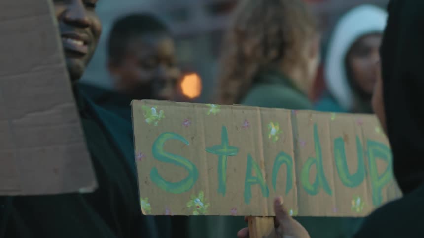 Protestors holding banners demonstrate in the street