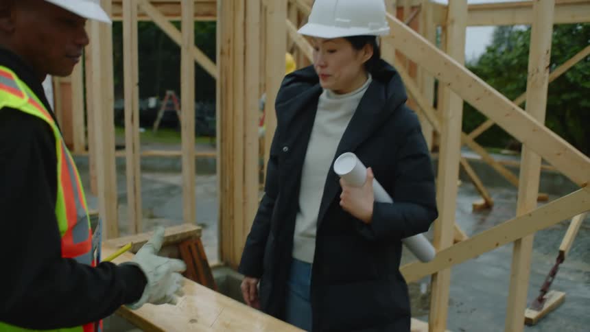 Two construction workers are talking at the job site