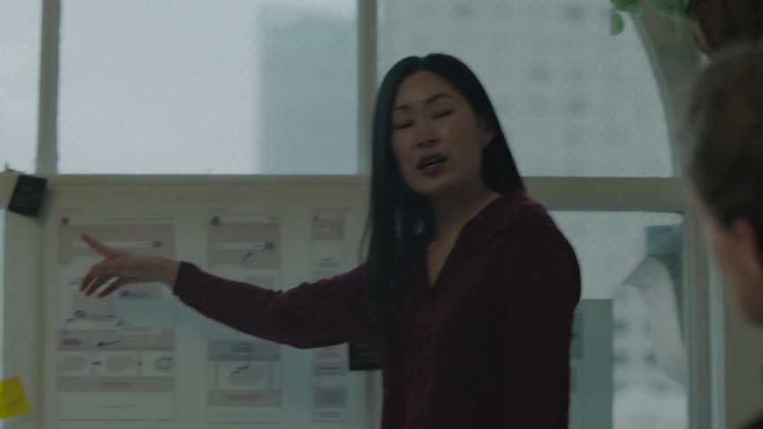 A group of coworkers are talking in their office together