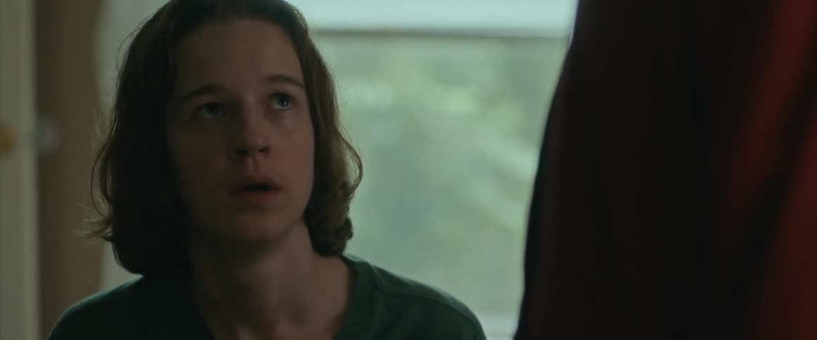 Sad boy reaction shot, looking up