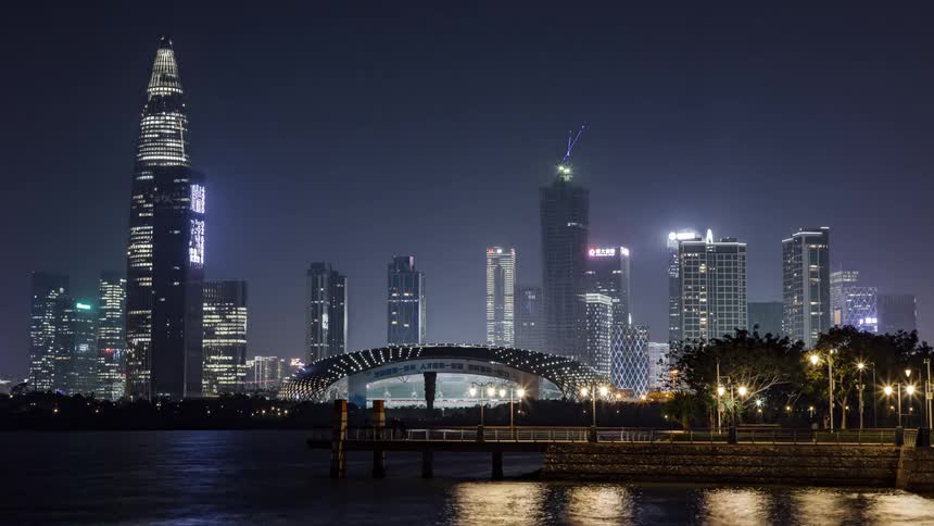 A city skyline near a water front is dispalyed