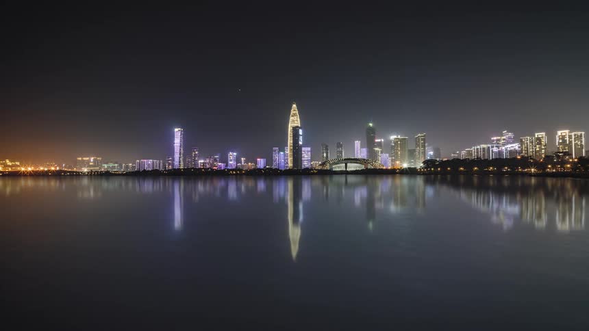 Time lapse view of a city skyline at night is displayed
