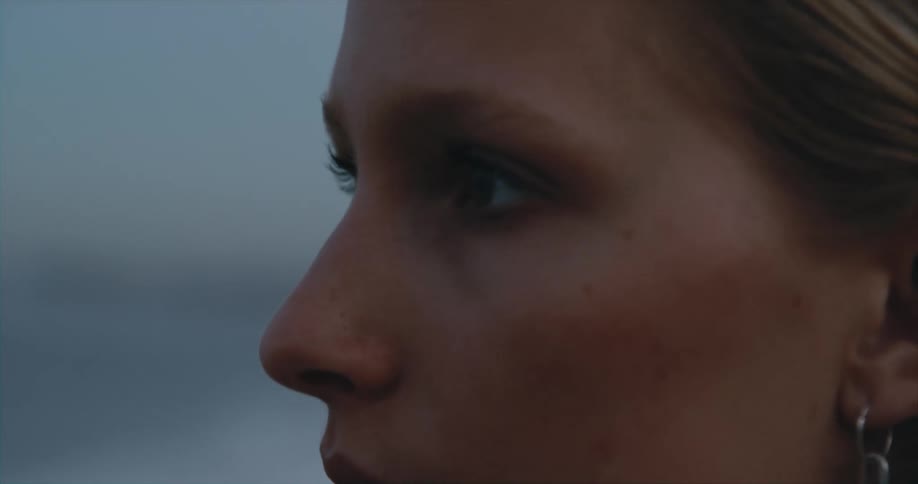 A woman is deep in thought as she stands outside