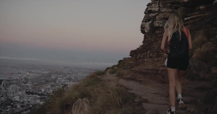 A woman is hiking up the mountain