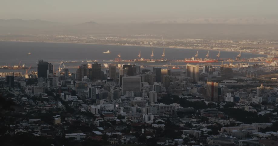 Aerial view of a downtown city by the coast is displayed