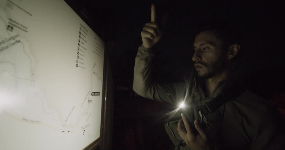 A man is talking and pointing to a map