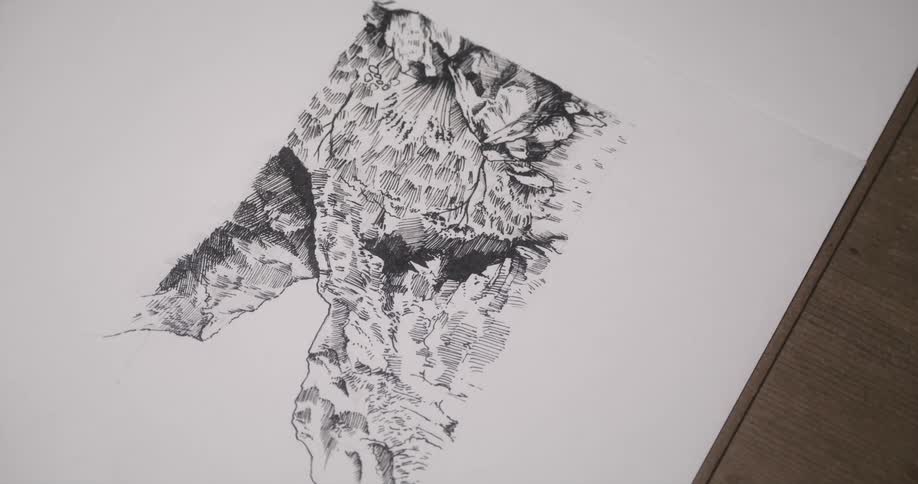 A person is sketching with a pen