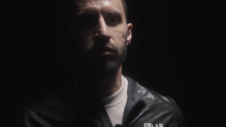 A man is jogging in the dark