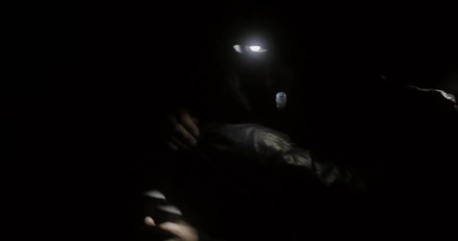People greet each other in the dark cave