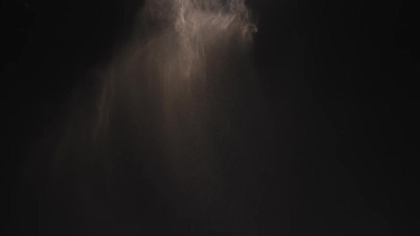 White fine powder falling against a blackboard