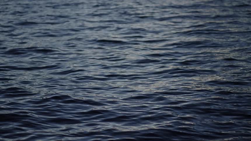 Sunlight shines on the water as it ripples and waves