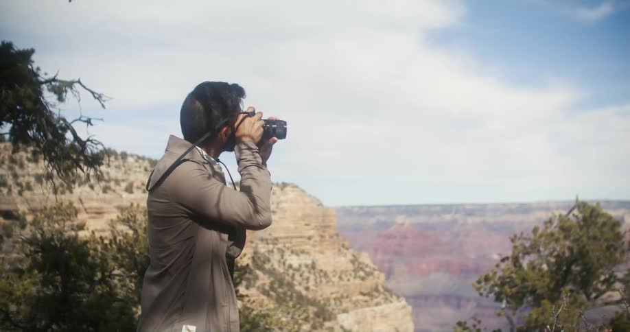 A man with a camera outdoors