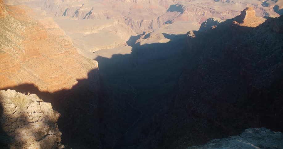 A vast canyon under a clear daytime sky