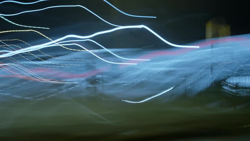 Cars move in traffic at night