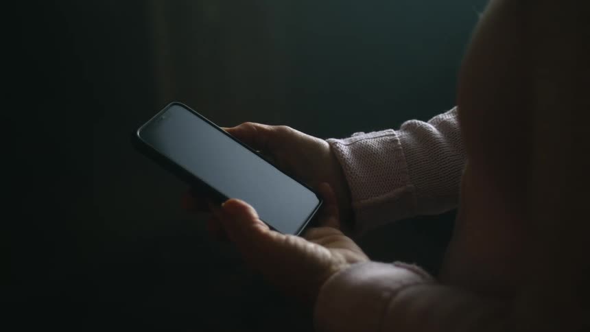 Close up of a woman holding a cell phone