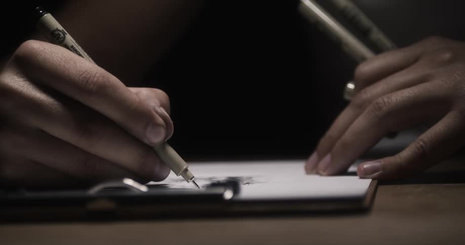 A person is drawing with a pen