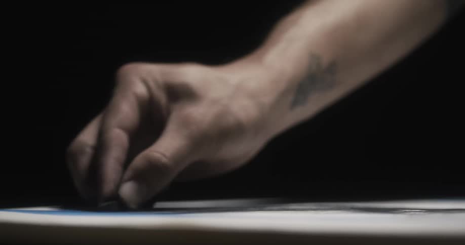 A person is drawing with charcoal