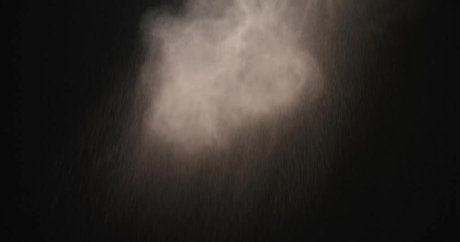 White powder falling against a black background