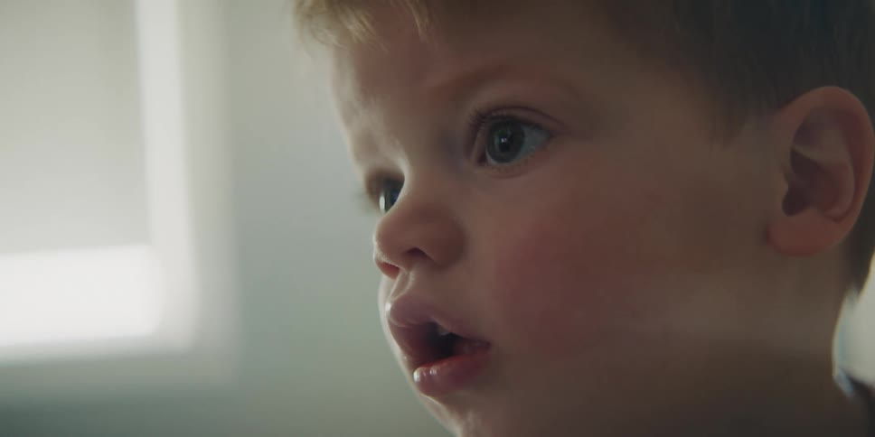 A little boy is watching something with his full attention