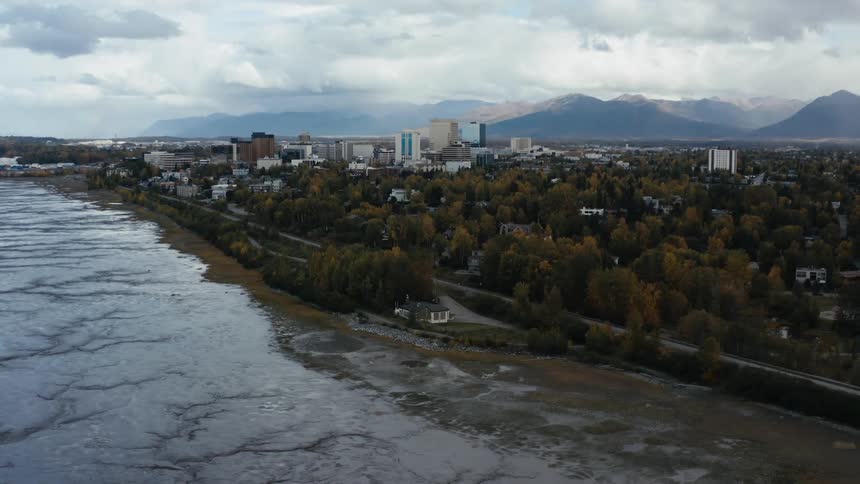 Aerail view of city next to frozen lake