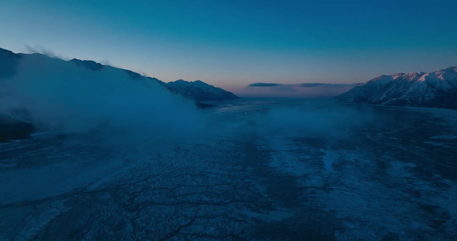 Fog moving across a mountain range