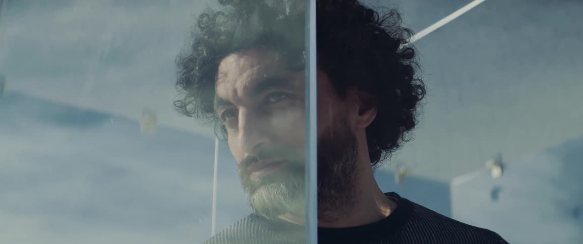 A man is trapped in a glass box