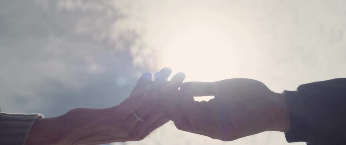 Close up of man and woman touching fingers and rubbing hands and holding hands