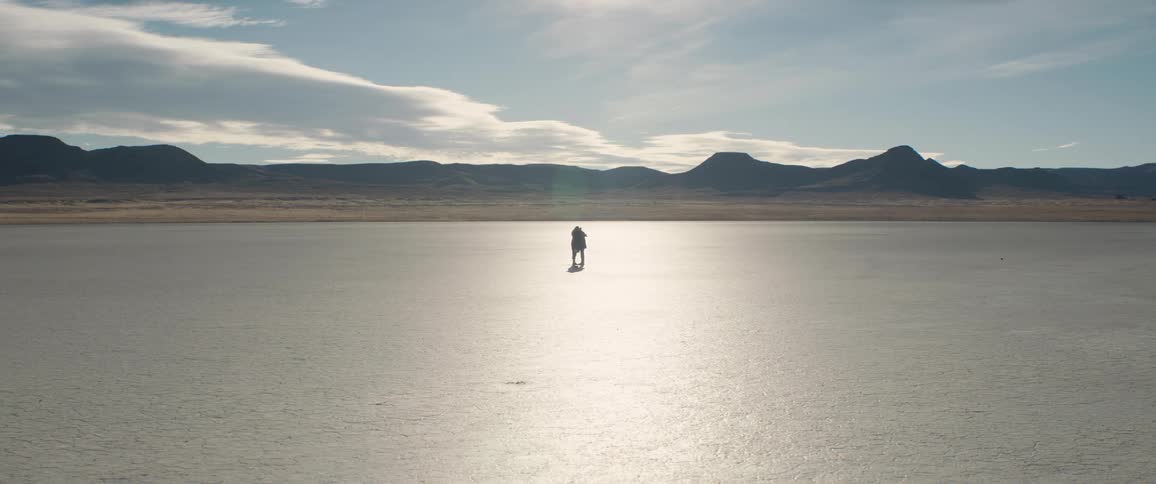 Two people hug in the desert