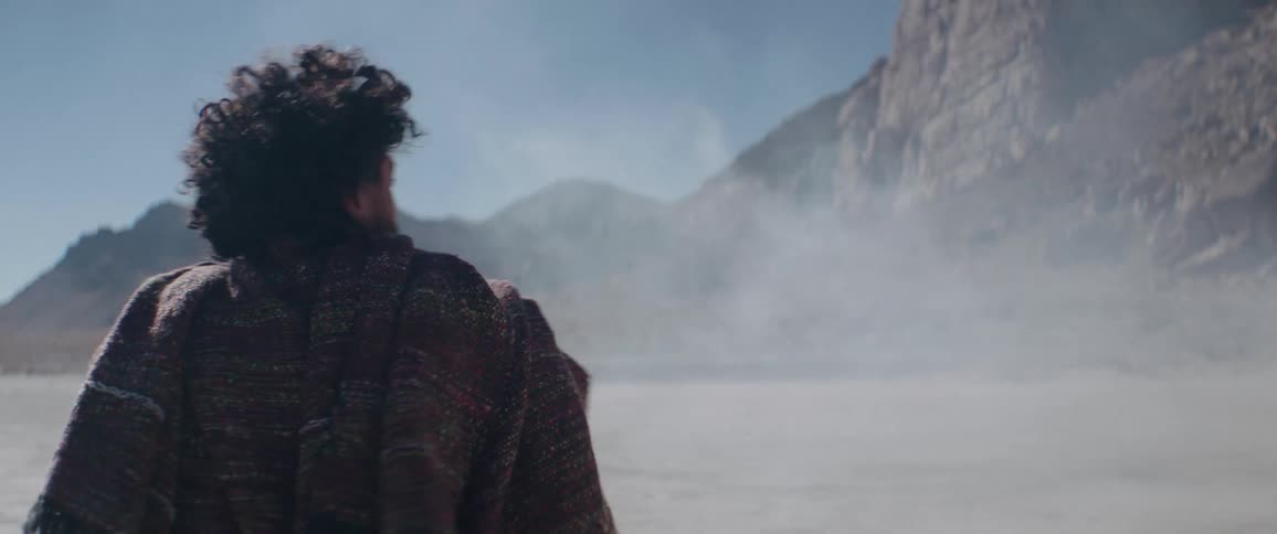 A man is spinning around in the desert